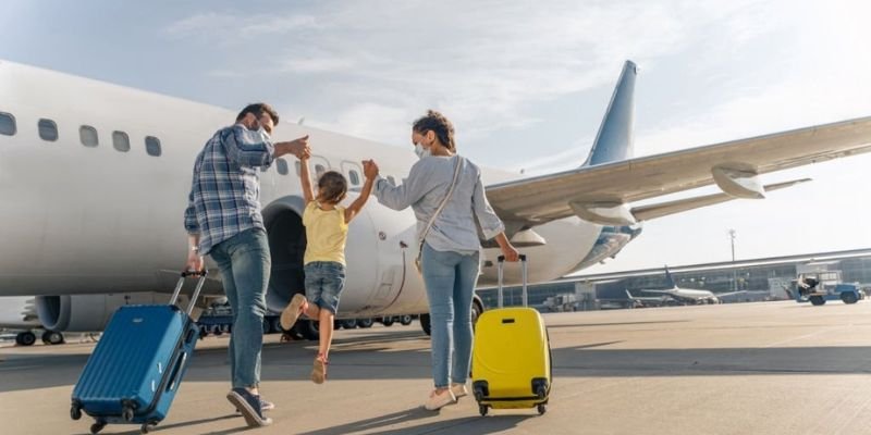 children with parents at an airport